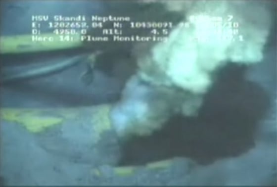 A tube was inserted Sunday into this pipe, seen earlier spewing oil and natural gas from the bottom of the Gulf of Mexico. BP hopes to eventually contain most of the leak via the tube, sending it to a tanker above.